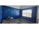 Bedroom with blue walls, mural, plank flooring, and natural light at 8612 Valley Ridge Ct, Orlando, FL 32818