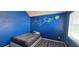 Bedroom with blue walls, mural, vinyl plank flooring, and natural light at 8612 Valley Ridge Ct, Orlando, FL 32818