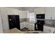 Modern kitchen with granite countertops, white cabinets, and stainless steel appliances at 8612 Valley Ridge Ct, Orlando, FL 32818