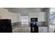 Well-lit kitchen featuring granite countertops, stainless steel appliances, and ample cabinet space at 8612 Valley Ridge Ct, Orlando, FL 32818