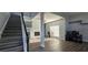 Open-concept living area features a fireplace, stairs, and attractive flooring creating inviting space at 8612 Valley Ridge Ct, Orlando, FL 32818