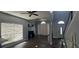 Open living room featuring wood floors, ceiling fan, neutral walls, and large window with a lot of natural light at 8612 Valley Ridge Ct, Orlando, FL 32818