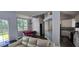 Open-concept living room featuring hardwood floors, dining area, and adjacent kitchen at 8612 Valley Ridge Ct, Orlando, FL 32818
