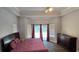Spacious bedroom featuring a large bed, wood floors, and tray ceilings at 8612 Valley Ridge Ct, Orlando, FL 32818