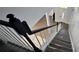 Bright staircase features hardwood floors and a white railing, leading to the home's entry at 8612 Valley Ridge Ct, Orlando, FL 32818