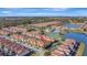 Aerial view features resort amenities, a tranquil lake, and lush landscaping at 8919 Bismarck Palm Rd, Kissimmee, FL 34747