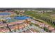 Aerial view showcases resort amenities, a tranquil lake, lush landscaping, and community atmosphere at 8919 Bismarck Palm Rd, Kissimmee, FL 34747