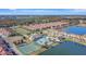 Aerial view of the community with resort-style pool, clubhouse, tennis and basketball courts with lake access at 8919 Bismarck Palm Rd, Kissimmee, FL 34747