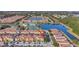 Aerial view features resort amenities, a tranquil lake, and lush landscaping at 8919 Bismarck Palm Rd, Kissimmee, FL 34747