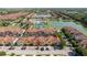 Aerial view of the townhomes showcasing the community amenities, including the pool, tennis courts, and sparkling lakes at 8919 Bismarck Palm Rd, Kissimmee, FL 34747