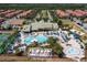 Aerial view of community clubhouse, pools, sun loungers, and lush landscaping at 8919 Bismarck Palm Rd, Kissimmee, FL 34747