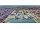 Aerial view of the community featuring a resort-style pool, clubhouse, tennis and basketball courts and lake at 8919 Bismarck Palm Rd, Kissimmee, FL 34747