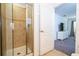 Walk-in shower featuring tiled walls and a glass door, adjacent to the doorway to the bedroom at 8919 Bismarck Palm Rd, Kissimmee, FL 34747