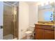Updated bathroom features a tiled shower, wood vanity with a sink, mirror and tiled floors at 8919 Bismarck Palm Rd, Kissimmee, FL 34747