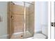 Bathroom boasts tiled shower with glass doors and neutral tiling at 8919 Bismarck Palm Rd, Kissimmee, FL 34747