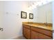 Well-lit bathroom with a double sink vanity, granite countertops, and modern fixtures at 8919 Bismarck Palm Rd, Kissimmee, FL 34747
