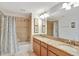 Bathroom featuring a double vanity with granite countertop and shower-tub combination at 8919 Bismarck Palm Rd, Kissimmee, FL 34747
