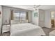 Comfortable bedroom featuring a large window with shades and ensuite bathroom at 8919 Bismarck Palm Rd, Kissimmee, FL 34747