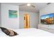 Well-lit bedroom featuring a dresser with a TV, closet space, and ensuite bathroom at 8919 Bismarck Palm Rd, Kissimmee, FL 34747