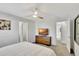 Bright bedroom with ceiling fan and a flat screen television with ensuite access at 8919 Bismarck Palm Rd, Kissimmee, FL 34747