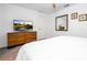 Carpeted bedroom featuring a dresser, a TV, a ceiling fan, and a large door closet at 8919 Bismarck Palm Rd, Kissimmee, FL 34747