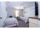 Cozy carpeted bedroom with two twin beds, a ceiling fan, and closet, providing a relaxing space at 8919 Bismarck Palm Rd, Kissimmee, FL 34747