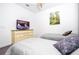 Bright bedroom with twin beds, soft neutral tones, and pleasant decor, creating a peaceful ambiance at 8919 Bismarck Palm Rd, Kissimmee, FL 34747