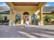 Clubhouse entrance featuring columns and landscaped surroundings at 8919 Bismarck Palm Rd, Kissimmee, FL 34747