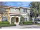 Charming two-story townhome with a well-maintained lawn, neat shrubbery, and a decorative tile roof at 8919 Bismarck Palm Rd, Kissimmee, FL 34747