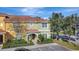 Exterior elevation of this home shows the roof, mature landscaping, and parking in front at 8919 Bismarck Palm Rd, Kissimmee, FL 34747