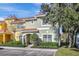 Charming two-story townhome with a well-maintained lawn, neat shrubbery, and a decorative tile roof at 8919 Bismarck Palm Rd, Kissimmee, FL 34747