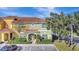 Charming two-story townhome boasts colorful facade, well-kept landscaping, and convenient parking spaces at 8919 Bismarck Palm Rd, Kissimmee, FL 34747