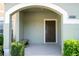 Inviting front porch featuring a seating area and a well-lit entrance, adding charm to the home's facade at 8919 Bismarck Palm Rd, Kissimmee, FL 34747