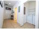 View of the tiled hallway, foyer, and laundry closet with washer and dryer at 8919 Bismarck Palm Rd, Kissimmee, FL 34747
