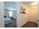 Hallway that features carpet and decorations and is adjacent to a bedroom with a seating area at 8919 Bismarck Palm Rd, Kissimmee, FL 34747