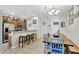 Open-concept kitchen with stainless steel appliances, granite countertops, breakfast bar and tiled floors at 8919 Bismarck Palm Rd, Kissimmee, FL 34747