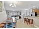 Open-concept kitchen with stainless steel appliances, granite countertops, and adjacent dining and living areas at 8919 Bismarck Palm Rd, Kissimmee, FL 34747