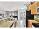 Modern kitchen with stainless steel appliances, granite countertops, and an open view to the living room at 8919 Bismarck Palm Rd, Kissimmee, FL 34747