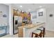 Bright kitchen with stainless steel appliances, granite countertops, breakfast bar, and light wood cabinetry at 8919 Bismarck Palm Rd, Kissimmee, FL 34747