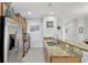 Well-appointed kitchen with stainless steel appliances, granite countertops, and tiled floors at 8919 Bismarck Palm Rd, Kissimmee, FL 34747