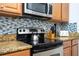 Kitchen view showing oven, range and granite countertops at 8919 Bismarck Palm Rd, Kissimmee, FL 34747