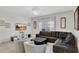 Comfortable living room with tile floors, a large sectional sofa, and natural light at 8919 Bismarck Palm Rd, Kissimmee, FL 34747