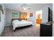 Comfortable main bedroom featuring carpet, a ceiling fan, and an ensuite bathroom with granite vanity top at 8919 Bismarck Palm Rd, Kissimmee, FL 34747