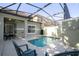 Refreshing screened-in pool area with lush landscaping and outdoor seating for relaxing at 8919 Bismarck Palm Rd, Kissimmee, FL 34747