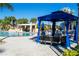 Relaxing poolside cabana with comfortable seating near a rock waterfall feature at 8919 Bismarck Palm Rd, Kissimmee, FL 34747