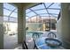 Relaxing screened-in pool area with a table and chairs for outdoor dining at 8919 Bismarck Palm Rd, Kissimmee, FL 34747