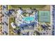 Aerial view of a large community pool, clubhouse, tennis and basketball courts and sand volleyball at 8919 Bismarck Palm Rd, Kissimmee, FL 34747