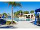 Resort-style pool with water feature, palm trees, and ample seating for relaxation and leisure at 8919 Bismarck Palm Rd, Kissimmee, FL 34747