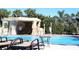 Relax by the pool with a rock waterfall, lounge chairs, and lush landscaping at 8919 Bismarck Palm Rd, Kissimmee, FL 34747