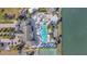 Aerial view of community pool, clubhouse, tennis and basketball courts and sand volleyball with lake access at 8919 Bismarck Palm Rd, Kissimmee, FL 34747
